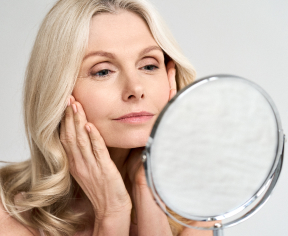 woman looking at herself in mirror