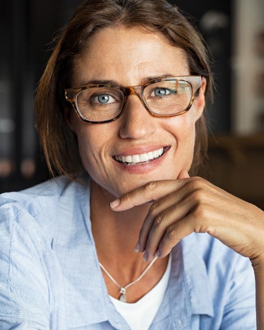 woman with glasses smiling