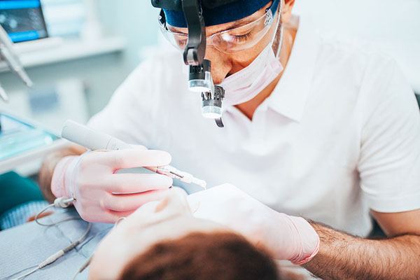 dentist performing a deep cleaning for a patient