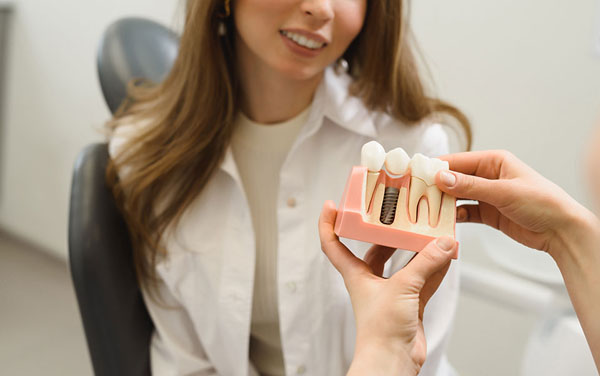 patient being shown what a dental implant looks like